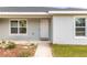 Close-up of a front door with a neutral color palette and a small porch at 13561 Sw 85Th Pl, Dunnellon, FL 34432