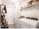 Laundry room with modern washer and dryer, overhead storage, and vinyl flooring at 13561 Sw 85Th Pl, Dunnellon, FL 34432