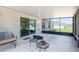 Covered patio with patio furniture overlooking a spacious backyard at 13561 Sw 85Th Pl, Dunnellon, FL 34432