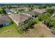 An aerial view of a home with a screened-in patio and lush landscaping in a residential neighborhood at 1377 Sw 161St Pl, Ocala, FL 34473