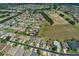 An aerial view of houses on a street with a golf course nearby at 1377 Sw 161St Pl, Ocala, FL 34473