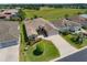An aerial view shows this single-story home with a long driveway in a manicured, green lawn setting at 1377 Sw 161St Pl, Ocala, FL 34473