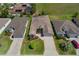 This is an aerial view showing the home nestled between two other homes and an expansive green space behind at 1377 Sw 161St Pl, Ocala, FL 34473