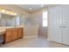 Bathroom featuring a double vanity, a walk-in shower, and tile flooring at 1377 Sw 161St Pl, Ocala, FL 34473