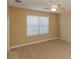 Bedroom features a ceiling fan, a large window with blinds, and plush carpeting at 1377 Sw 161St Pl, Ocala, FL 34473