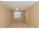 Inviting bedroom with a ceiling fan, a large window, neutral carpeting and natural light at 1377 Sw 161St Pl, Ocala, FL 34473