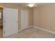 This bedroom includes carpet, a ceiling fan, a closet, and white doors at 1377 Sw 161St Pl, Ocala, FL 34473