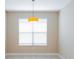 Bright dining area with tiled floors and a modern pendant light fixture at 1377 Sw 161St Pl, Ocala, FL 34473