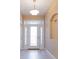 Bright entryway with decorative glass door and sidelights, beige walls and a built in wall rack at 1377 Sw 161St Pl, Ocala, FL 34473