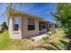 Charming home exterior with a screened lanai, paved walkway, and lush green lawn at 1377 Sw 161St Pl, Ocala, FL 34473
