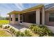 Exterior view with a screened lanai, manicured landscaping, and a paved walkway at 1377 Sw 161St Pl, Ocala, FL 34473