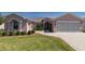 Charming single-story home featuring manicured landscaping and a two-car garage at 1377 Sw 161St Pl, Ocala, FL 34473