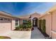 Home's front entrance is adorned with lovely plants and a well-manicured lawn at 1377 Sw 161St Pl, Ocala, FL 34473