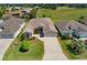 Beautifully landscaped front yard featuring lush green lawns, a variety of plants, and a two-car garage at 1377 Sw 161St Pl, Ocala, FL 34473