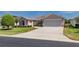 This shot highlights the home's easy-access drive, two-car garage, and well-maintained front lawn at 1377 Sw 161St Pl, Ocala, FL 34473