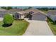 This home shows off a well-manicured lawn and a tidy foundation of well-placed shrubs and blooming plants at 1377 Sw 161St Pl, Ocala, FL 34473