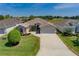 The home boasts an easy-access drive and manicured lawn with well-placed hedges and an interesting green shrub at 1377 Sw 161St Pl, Ocala, FL 34473