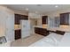 Well-lit kitchen featuring dark wood cabinets, white countertops, and stainless steel appliances at 1377 Sw 161St Pl, Ocala, FL 34473