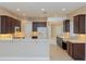 Open kitchen design with dark cabinets, stainless appliances, and a bright, airy feel at 1377 Sw 161St Pl, Ocala, FL 34473