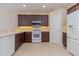 Well-lit kitchen features modern appliances, dark wood cabinets, and sleek countertops at 1377 Sw 161St Pl, Ocala, FL 34473