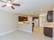 Spacious kitchen with tile floors, dark cabinetry, a breakfast bar, and modern appliances at 1377 Sw 161St Pl, Ocala, FL 34473