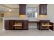 Kitchen features dark wood cabinets with under-cabinet lighting, and custom pull-out shelving at 1377 Sw 161St Pl, Ocala, FL 34473