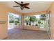 Enjoy this open lanai with tile floors, ceiling fan, and views of the landscaped backyard at 1377 Sw 161St Pl, Ocala, FL 34473