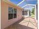 Relax in the screened lanai, featuring tile floors and a view of the outdoors at 1377 Sw 161St Pl, Ocala, FL 34473