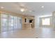 Spacious living room with tile flooring, recessed lighting, and sliding glass doors to the patio at 1377 Sw 161St Pl, Ocala, FL 34473