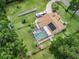 View of home with fenced in pool, solar panels, RV parking and beautiful landscaping at 16 Count Fleet Dr, Ocala, FL 34482