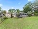 Spacious backyard featuring a screened pool, lush lawn, and mature trees at 16 Count Fleet Dr, Ocala, FL 34482