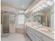 Well-lit bathroom showcases a double sink vanity, separate shower, and a luxurious soaking tub at 16 Count Fleet Dr, Ocala, FL 34482