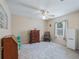 Neutral bedroom provides a ceiling fan, carpet, natural light, and closet storage at 16 Count Fleet Dr, Ocala, FL 34482