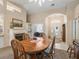 Bright dining area featuring a fireplace, arched doorway, and view of the front door and adjacent room at 16 Count Fleet Dr, Ocala, FL 34482