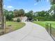 Long, private driveway leads to a three-car garage home featuring solar panels and ample parking space for RV at 16 Count Fleet Dr, Ocala, FL 34482