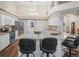 Bright kitchen with granite countertops, stainless steel appliances, and a functional island with barstool seating at 16 Count Fleet Dr, Ocala, FL 34482