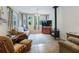 Inviting living room features tile floors, a cozy sitting area, and large windows providing ample natural light at 16 Count Fleet Dr, Ocala, FL 34482