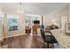Bright living area with wood floors, chandelier, and open concept design, flowing seamlessly into an adjacent space at 16 Count Fleet Dr, Ocala, FL 34482