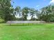 Array of solar panels in a green grass field at 16 Count Fleet Dr, Ocala, FL 34482