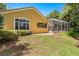 Backyard view featuring a patio area and screened enclosure perfect for outdoor relaxation at 1675 Se 73Rd Pl, Ocala, FL 34480