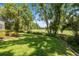 Expansive backyard featuring a lush lawn with a golf course view, perfect for outdoor enjoyment at 1675 Se 73Rd Pl, Ocala, FL 34480