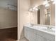 Bathroom with double sink vanity, a large mirror, and view into the Primary bedroom at 1675 Se 73Rd Pl, Ocala, FL 34480