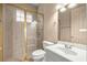 Bright bathroom featuring a glass shower, modern toilet, and a sink with white cabinetry at 1675 Se 73Rd Pl, Ocala, FL 34480
