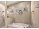 This spacious bathroom features a soaking tub, walk-in shower, and two windows with natural light at 1675 Se 73Rd Pl, Ocala, FL 34480