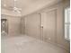 Spacious bedroom featuring neutral carpeting, soft paint, tray ceilings, and decorator wall sconces at 1675 Se 73Rd Pl, Ocala, FL 34480