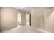 Bedroom with neutral carpet and walls featuring two doors, one leading to the bathroom, one to closet at 1675 Se 73Rd Pl, Ocala, FL 34480