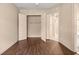 Bedroom closet featuring shelving and a view to an ensuite bathroom and dark hardwood floors at 1675 Se 73Rd Pl, Ocala, FL 34480