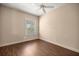 This empty bedroom has hardwood floors, a ceiling fan, plantation shutters, and neutral walls at 1675 Se 73Rd Pl, Ocala, FL 34480