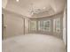 Spacious bedroom with tray ceiling, neutral carpeting, multiple windows and sliding glass doors for plenty of natural light at 1675 Se 73Rd Pl, Ocala, FL 34480