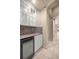 Convenient butler's pantry equipped with granite countertops, cabinets, and a wine cooler at 1675 Se 73Rd Pl, Ocala, FL 34480
